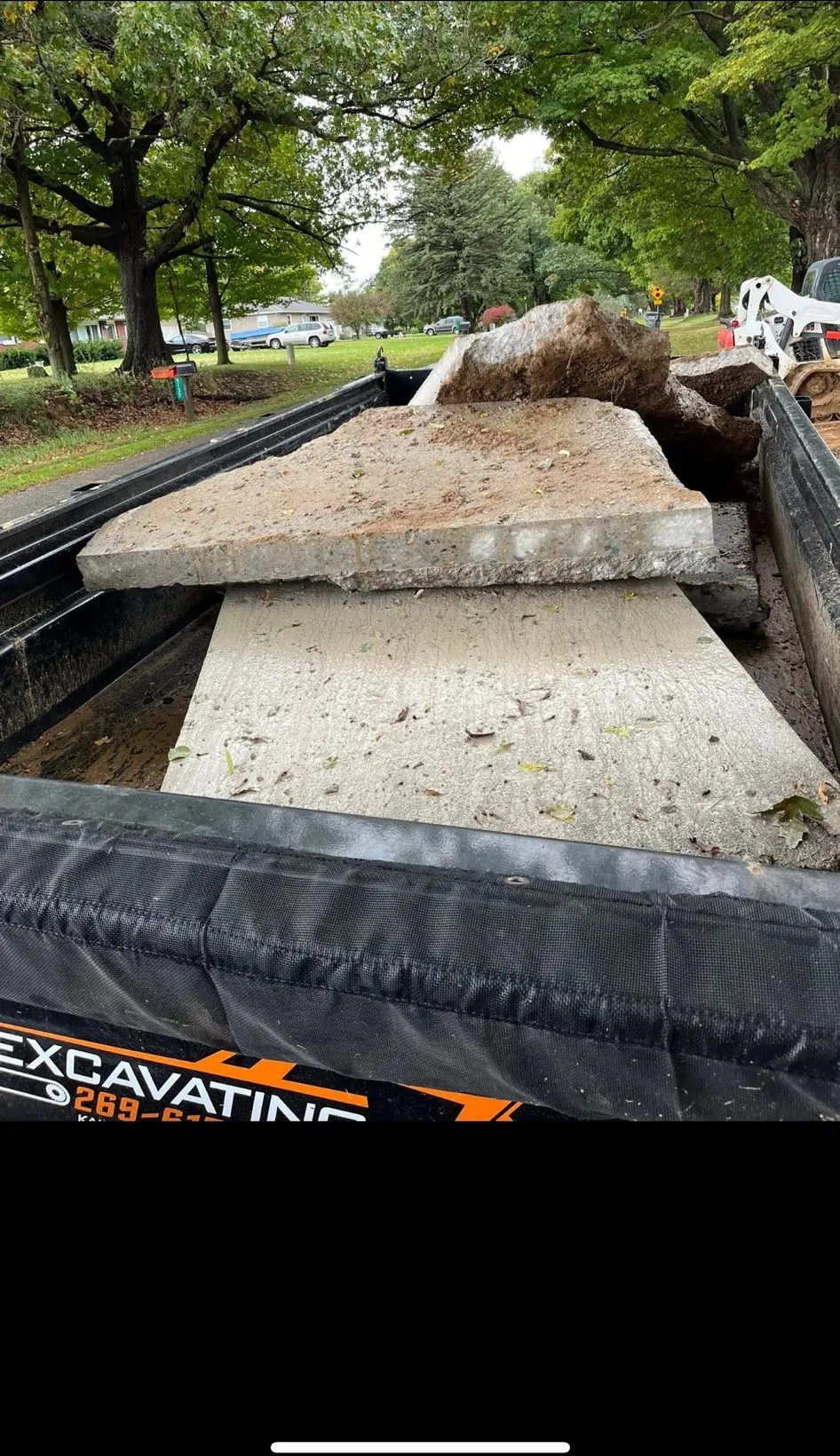Broken concrete loaded out on an E's Excavating dump trailer